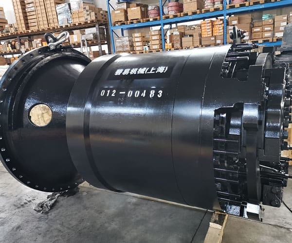 A large black cylinder sitting in a warehouse.