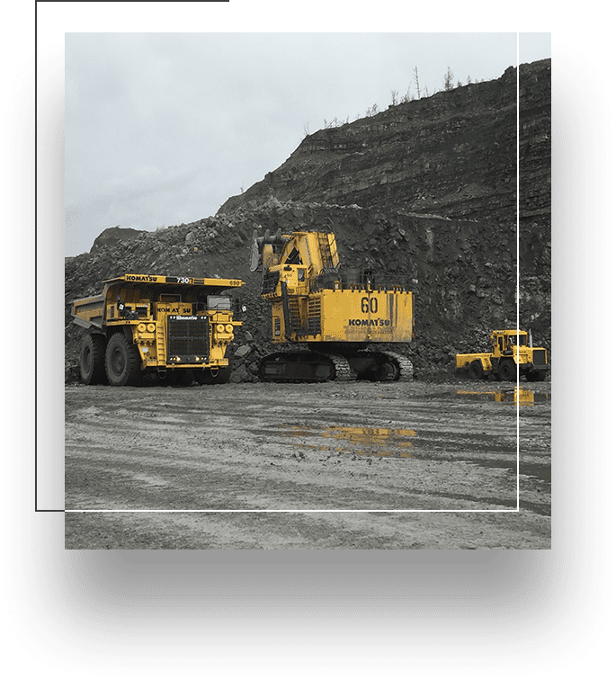 A black and white photo of three large trucks.