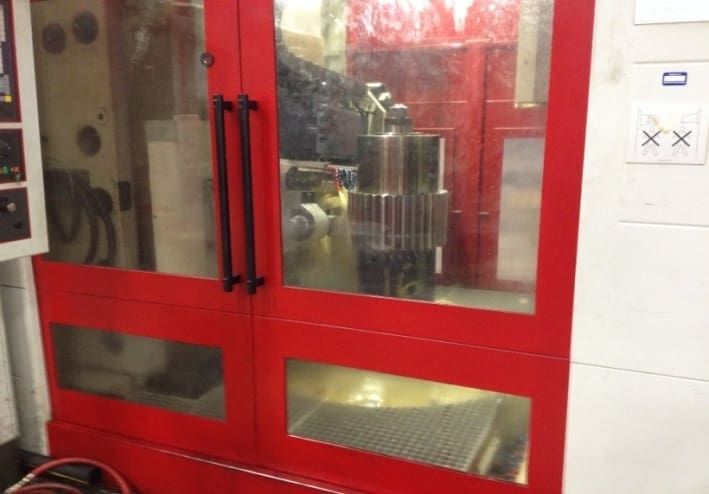 A red door with two glass windows and one window has a metal handle.