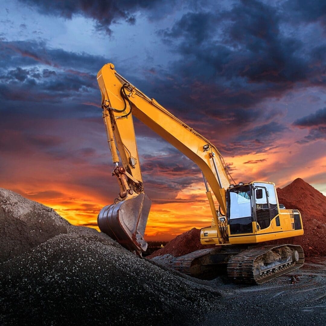 A yellow and black excavator on top of dirt.