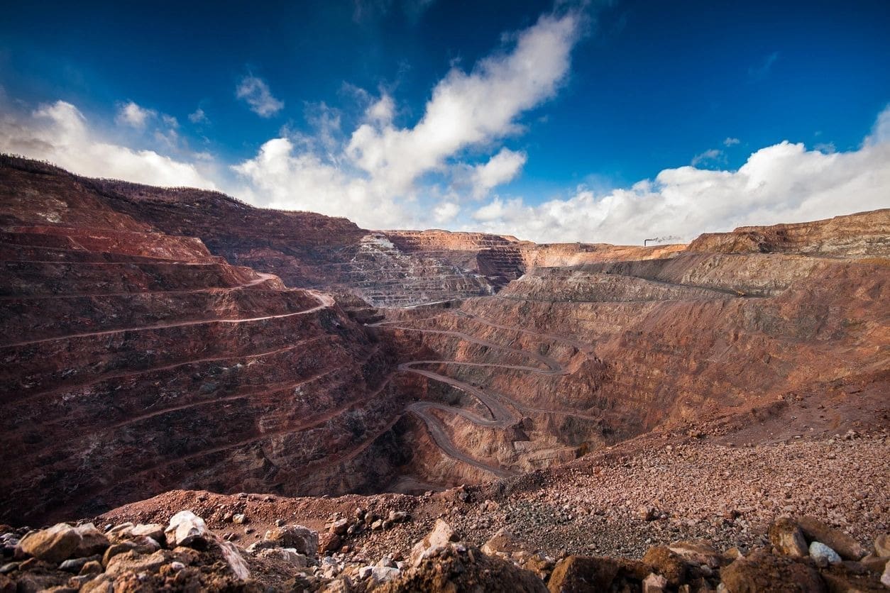 A view of the side of a mountain with a sky background