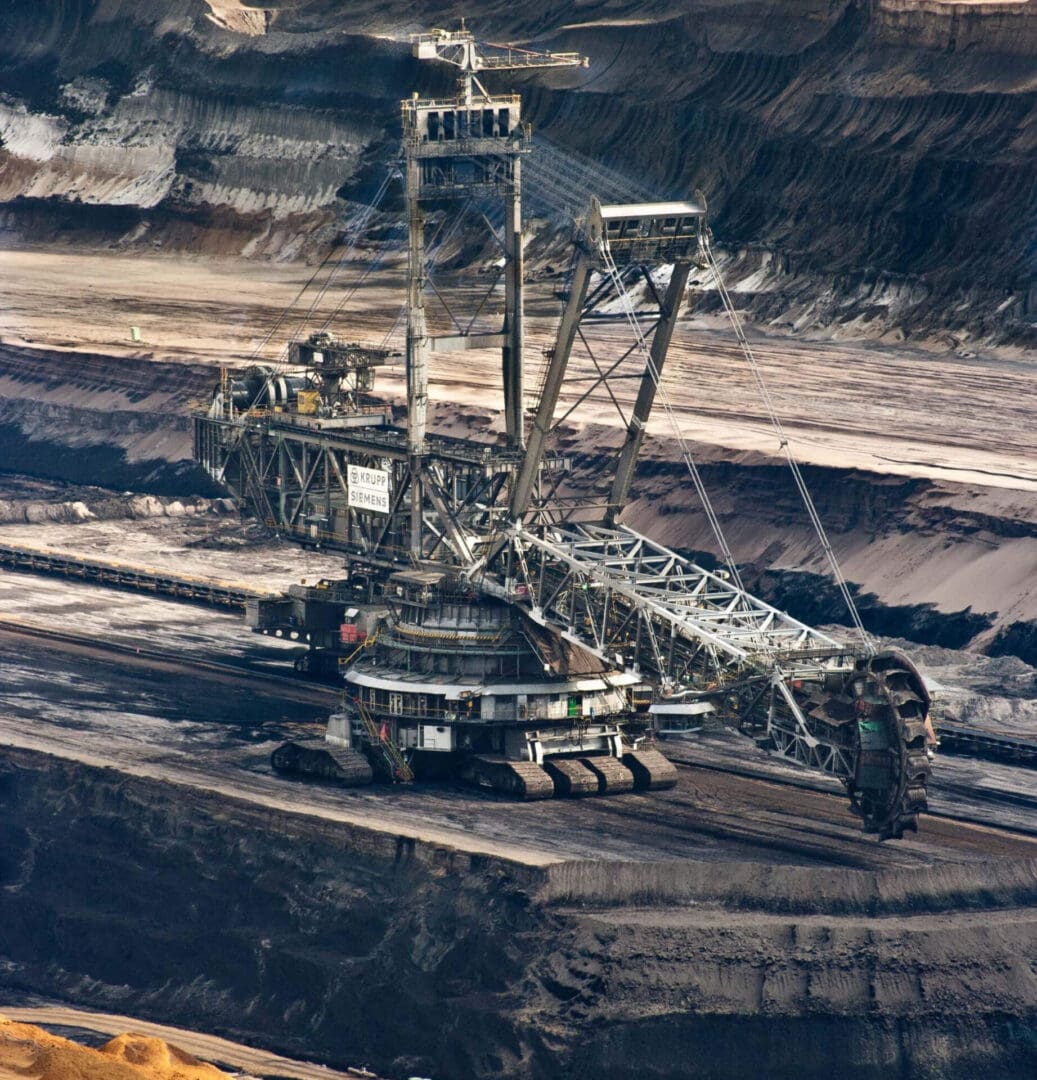 A large crane in the middle of an open pit.