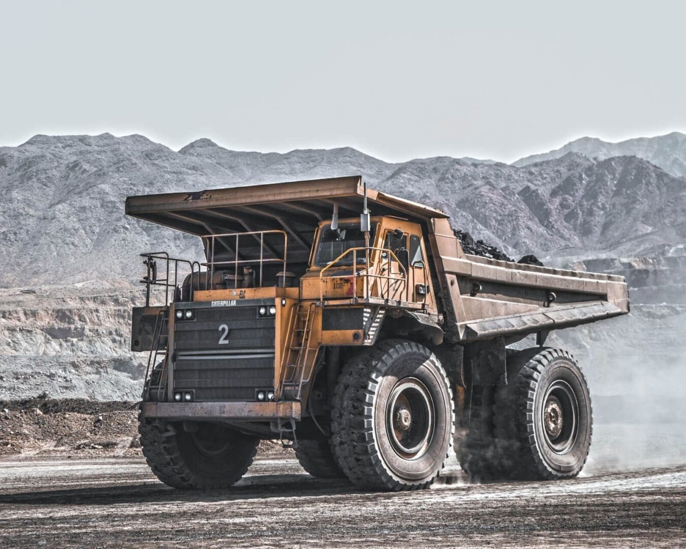 A large dump truck is parked on the side of a road.