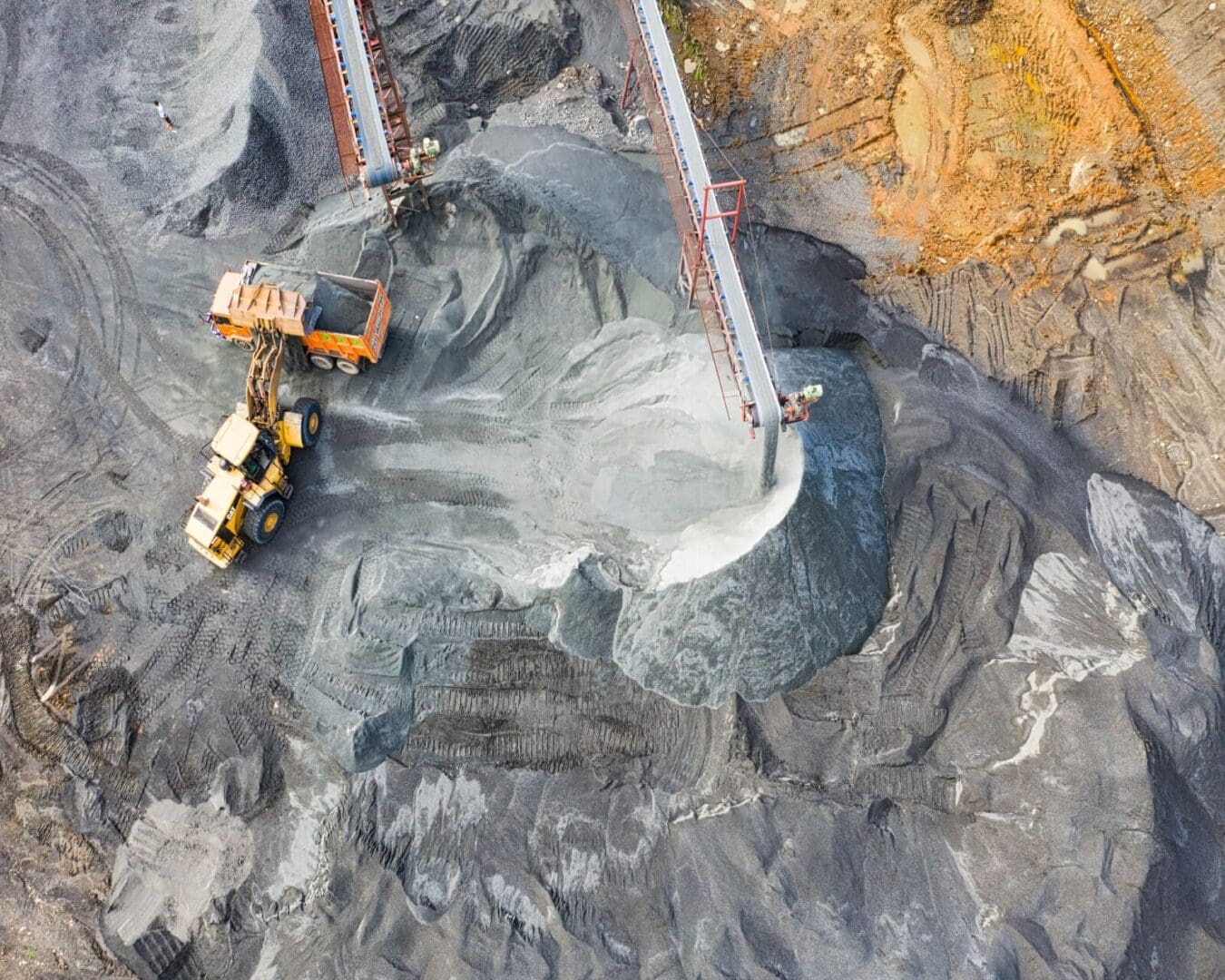 A large pile of rock is being loaded with rocks.